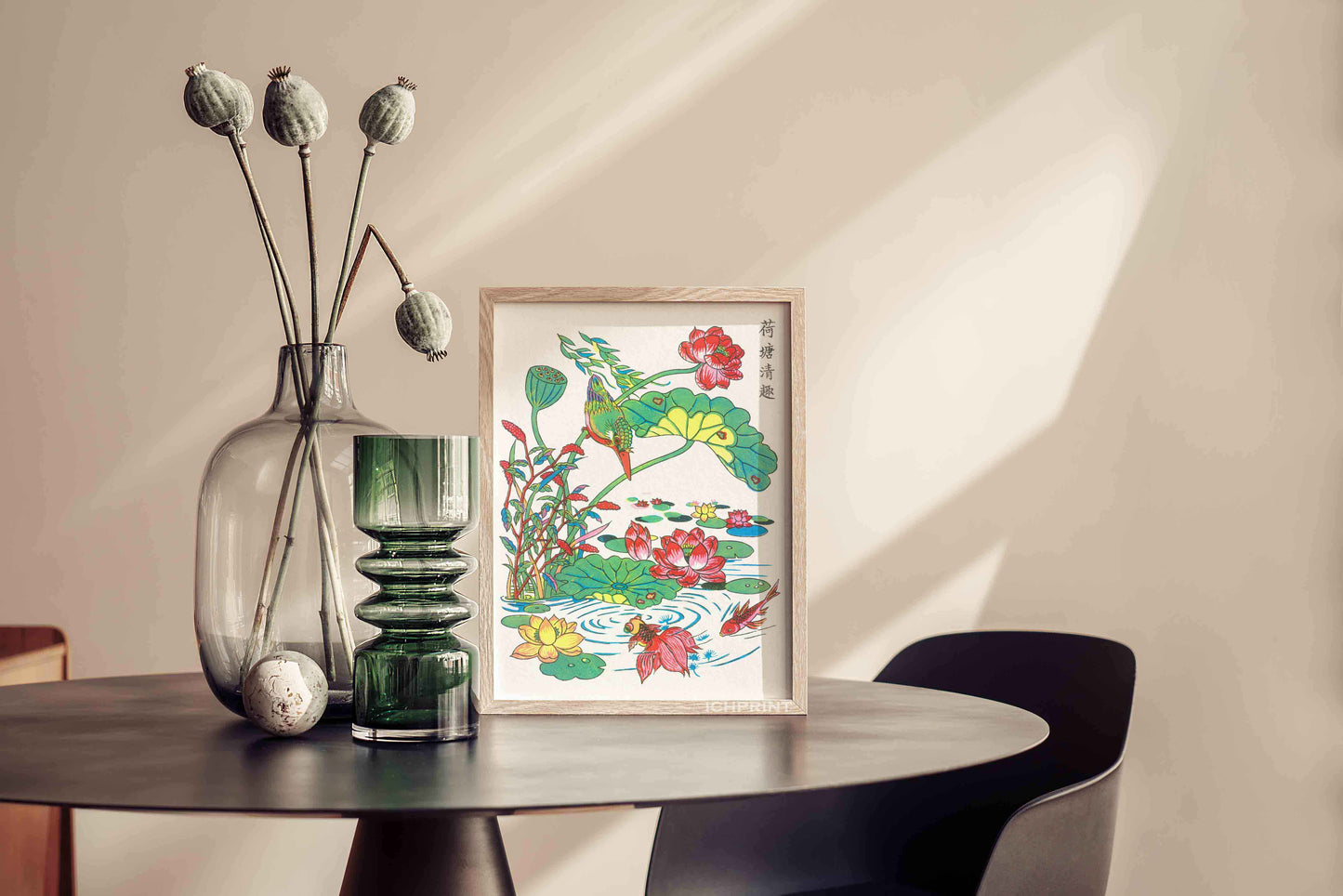 Woodblock print of a lotus pond scene displayed on a table, complemented by green glassware and dried floral décor.
#framed